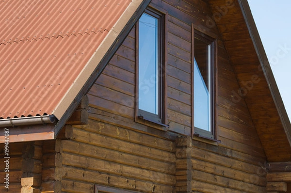 Fototapeta Type of an end face of a roof of the wooden two-storeyed rural house