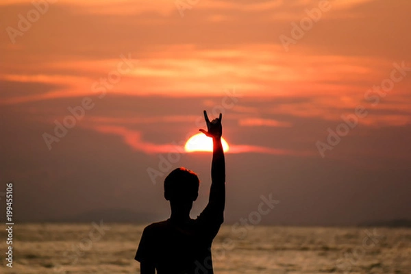 Obraz Silhouette Man is lifting love love hand.