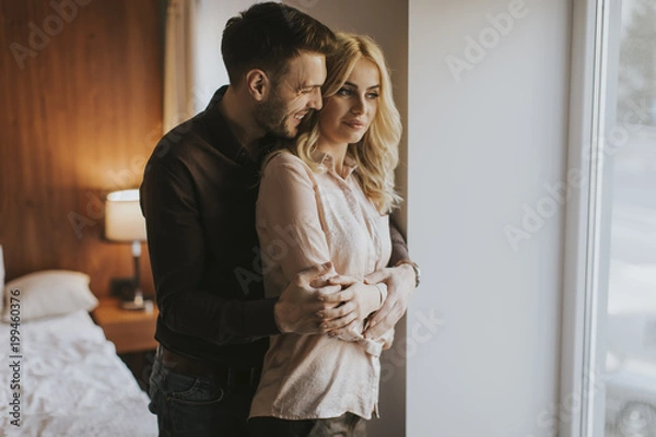 Fototapeta Loving couple by window in the room