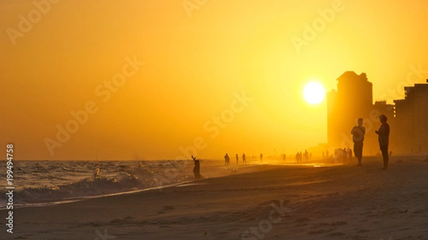 Obraz Sunset on Orange Beach Alabama with people in hazy fog