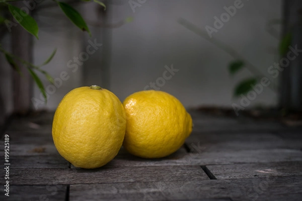 Fototapeta Lemons on a wooden background. Top view. Free space for text.