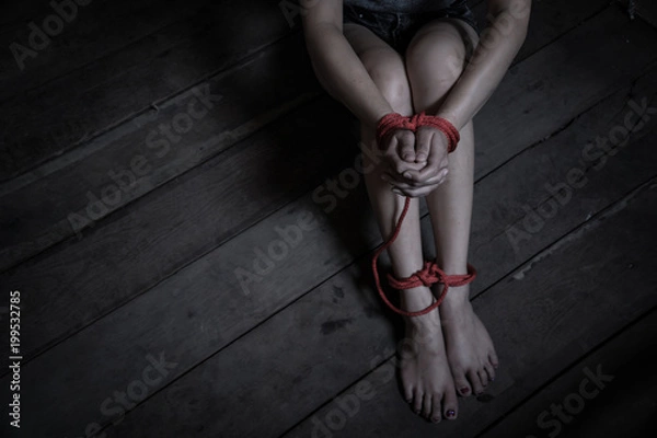 Fototapeta Victims of abducted women get wrists and feet in red..Hostage concept or female kidnapped from robber.