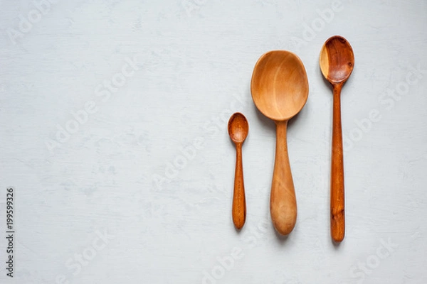Fototapeta Wooden spoons are handmade in different sizes.
