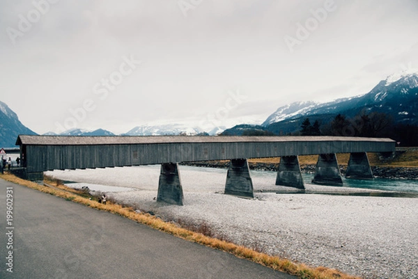 Obraz Old wooden bridge crossing the Rhine between Liechtenstein and Switzerland
