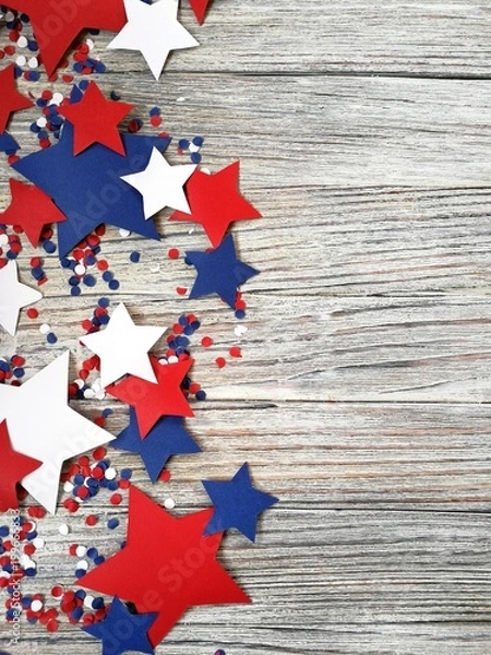 Fototapeta American independence Day, celebration, patriotism and holidays concept - flags and stars on the 4th of July party on top on wooden background