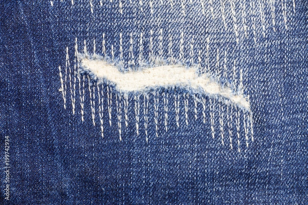 Fototapeta Jeans torn denim texture background.