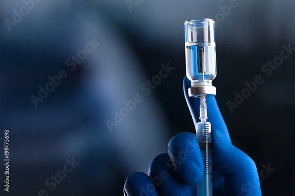 Fototapeta Doctor hand holds syringe and vaccine