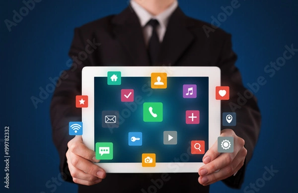 Fototapeta Businessman holding tablet with colorful applications
