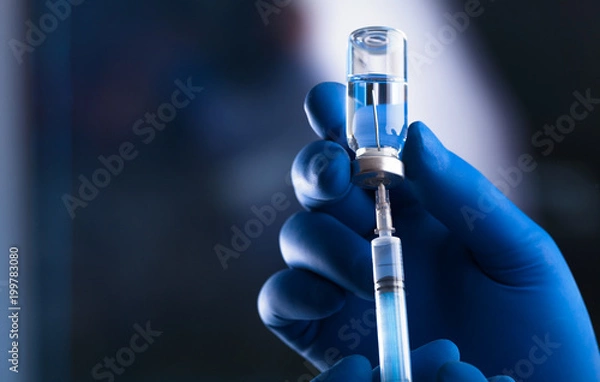 Fototapeta Medical hands holds syringe and vaccine