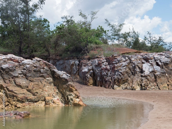 Fototapeta Two cliffs and tidal pool on tropical beach