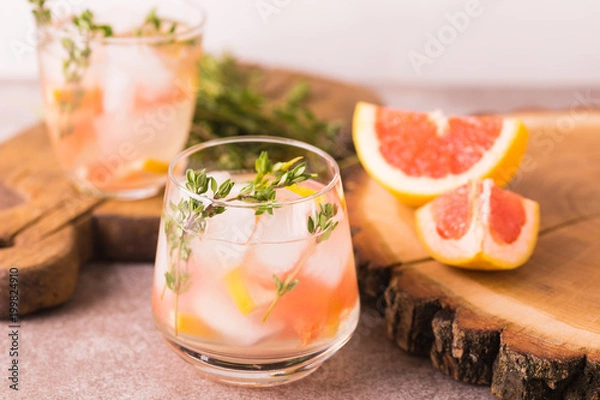 Fototapeta Gin bitter lemon with thyme and grapefruit. Fruit lemonade.