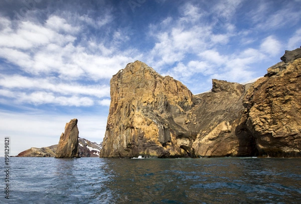 Fototapeta Giant cliffs rise from the ocean on Deception Island in Antarctica, also known as the Land of Fire and Ice because of the combination of glaciers and the active volcano that warms the surroundings.