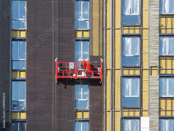Obraz Worker in the red building cradle