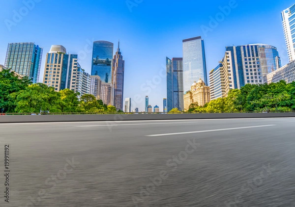 Obraz Through the empty asphalt pavement of modern cities in guangzhou, China.