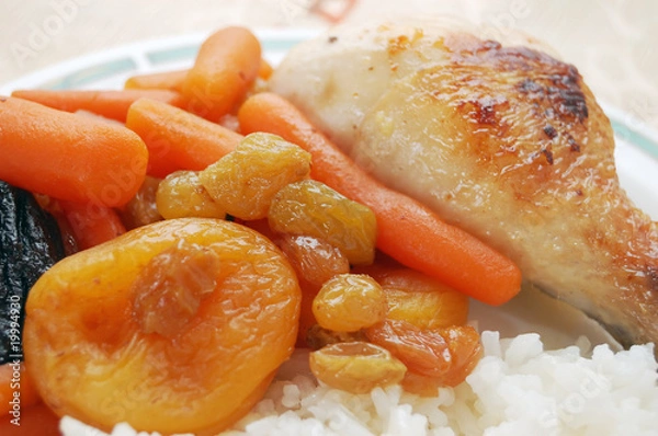 Fototapeta Stewed carrots with dry fruits, rice and chicken