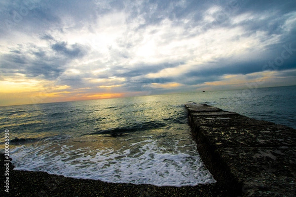 Obraz  Sunset on a stone pier.