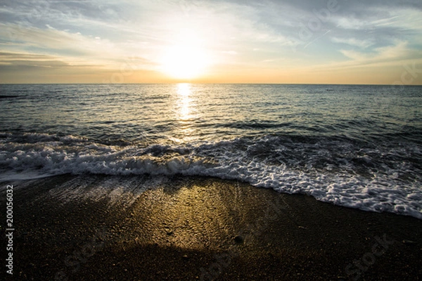 Obraz Coastal waves at sunset. Colorful sunset on a sea beach.