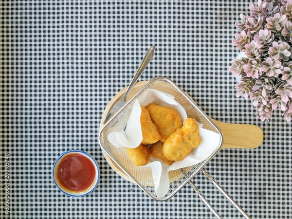 Fototapeta fried nuggets in in a frying pan on the table