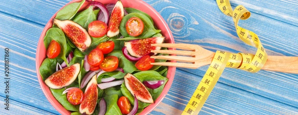 Obraz Fresh prepared fruit and vegetable salad, fork with tape measure, healthy lifestyle, slimming and nutrition concept