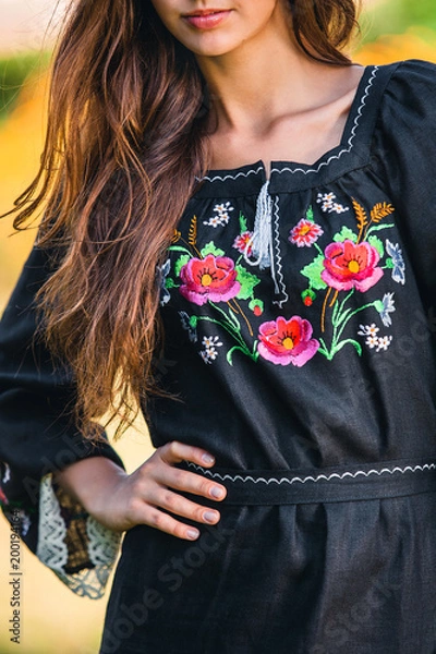 Obraz elegant black dress with embroidered flower pattern and white outline