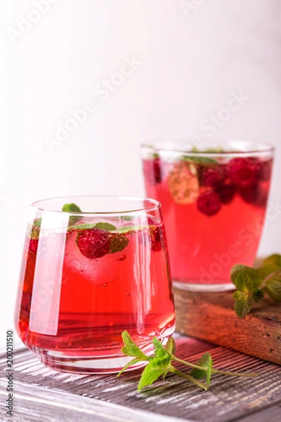 Fototapeta Aperitif with campari, mint and raspberry. Iced lemonade