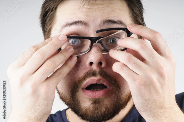 Obraz Shocked man with broken glasses on his face