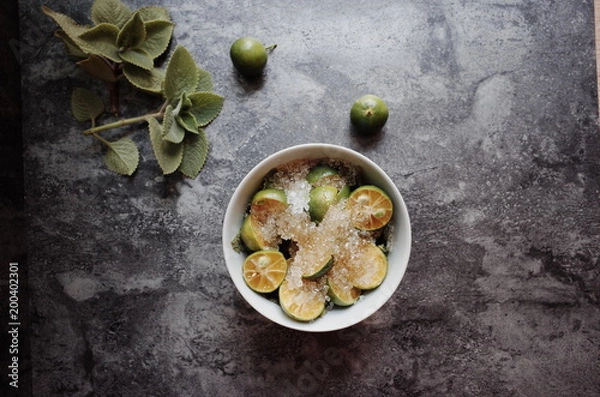 Fototapeta Healthy drink with fresh leaves, lemon, honey and sugar