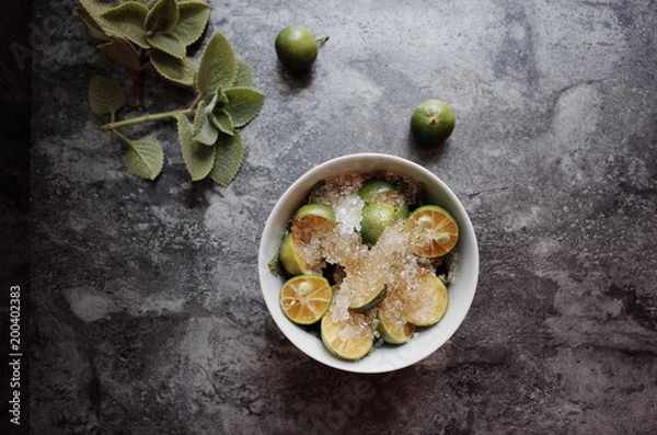 Fototapeta Healthy drink with fresh leaves, lemon, honey and sugar
