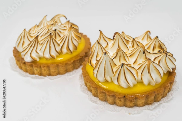 Fototapeta Yummy Lemon Meringues- isolated, studio shot of two lemon meringue tarts 