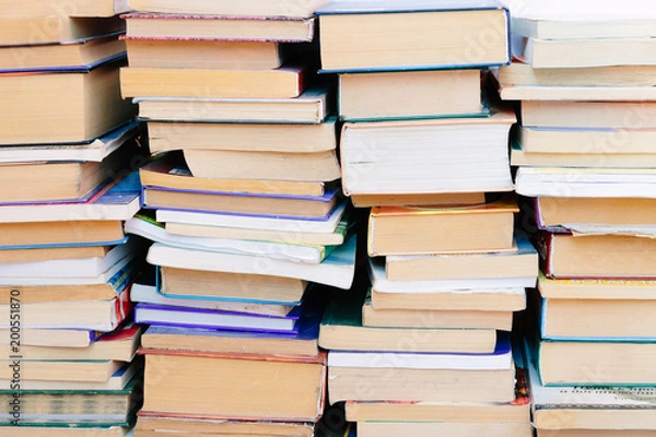 Fototapeta Stack of books background. many books piles.