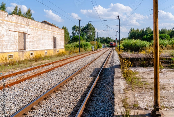 Obraz Train passing platform. A Diesel train seen speeding past a platform.