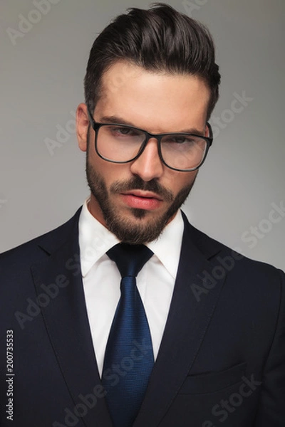 Fototapeta portrait of serious businessman with glasses thinking