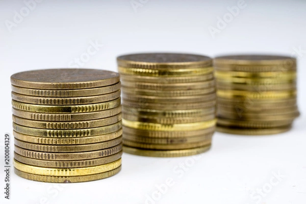 Fototapeta Coins stacked. Money lying on the table.