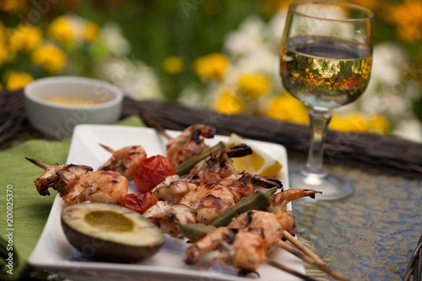 Fototapeta Grilled Shrimps Skewers for Dinner in Garden