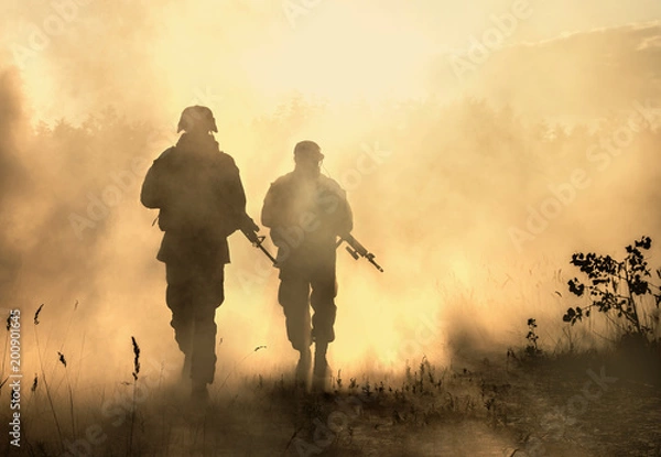 Fototapeta United States Marines in action. Military equipment, army helmet, warpaint, smoked dirty face, tactical gloves. Military action, desert battlefield, smoke grenades