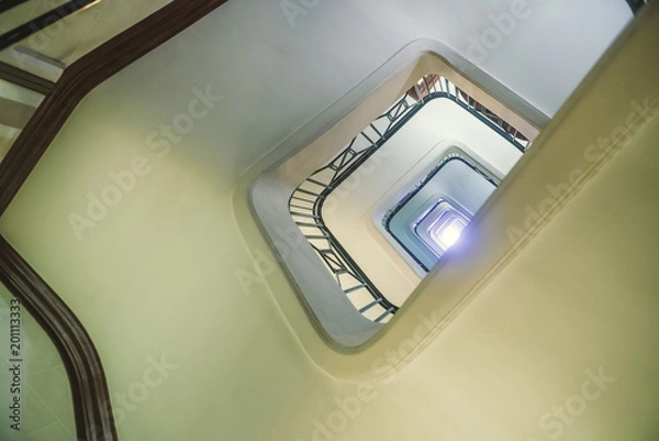 Obraz A huge spiral staircase, view from below.