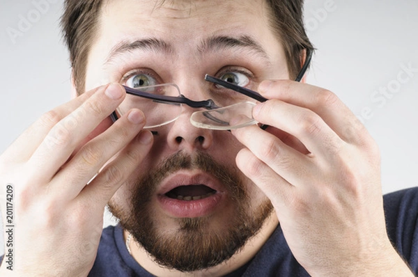 Obraz Shocked man with broken glasses on his face