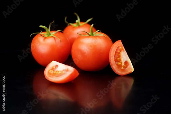 Obraz red tomatoes on a black background