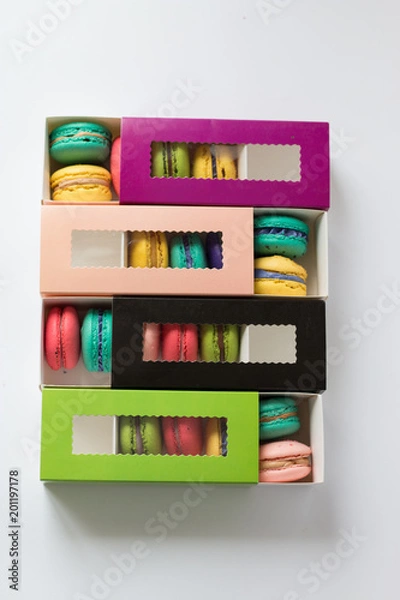 Fototapeta mix of macaroons in colored boxes