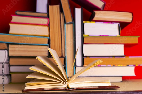 Fototapeta Open book, hardback books on bright colorful background.