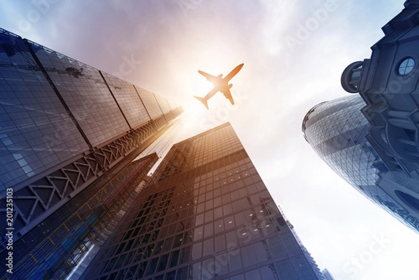 Obraz plane over highrise buildings