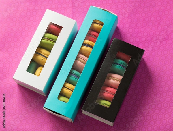 Fototapeta mix of macaroons in colored boxes
