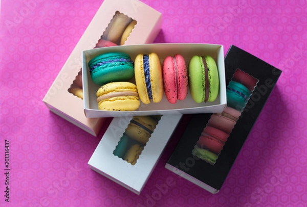 Fototapeta mix of macaroons in colored boxes