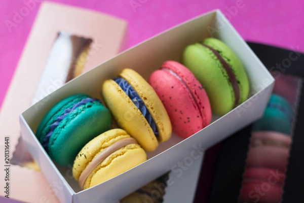 Fototapeta mix of macaroons in colored boxes