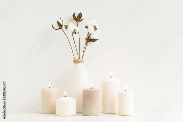 Fototapeta Spa composition. Candles, cotton flowers on white background. Flat lay, mock up. top view