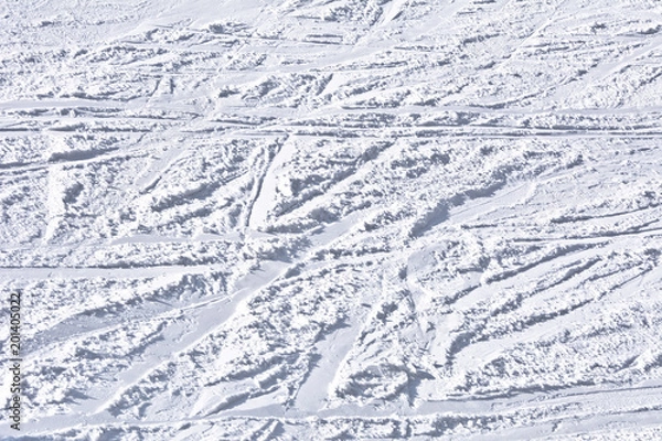 Obraz Ski slope with traces of skis on a sunny day.
Background, texture.
