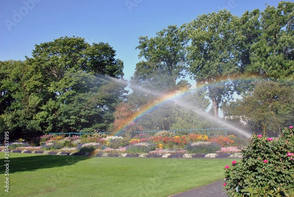 Obraz Botanical garden looking like a paradise with the water painting a rainbow in the sunlight.