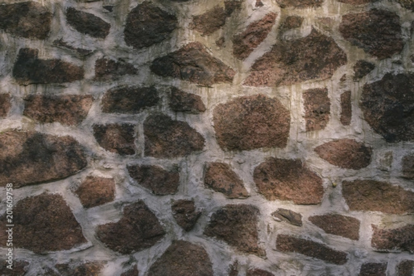Fototapeta Texture of a wall from various stone blocks creating a pattern, background.