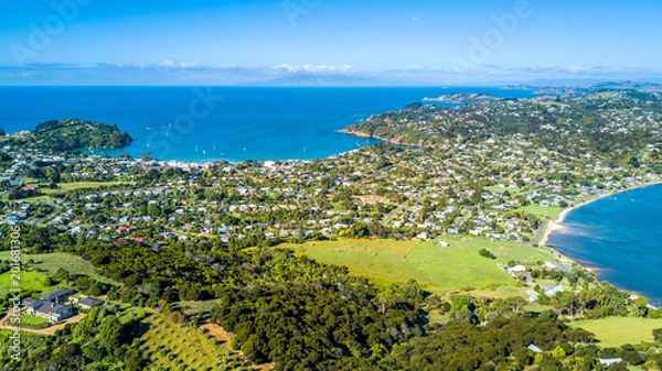 Obraz Aerial view on beautiful bay at sunny day with sandy beach and residential suburbs on the background. Waiheke Island, Auckland, New Zealand
