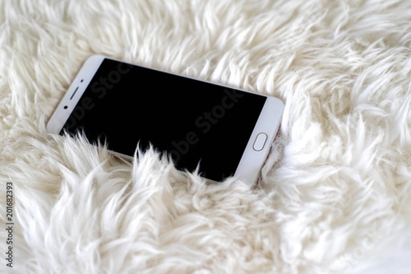 Obraz Smart phone on white carpet